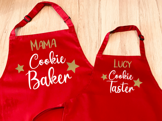 Set of 2 personalised aprons. One has Cookie Baker on it, the other has Cookie Taster on it