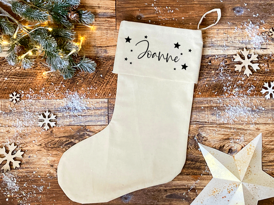 a calico christmas stocking, personalised with a name and decorated with stars